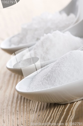 Image of three spoons with different salt