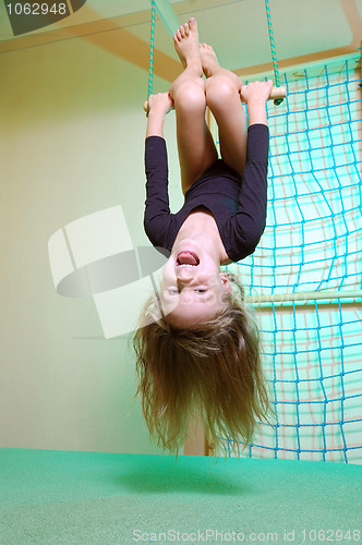 Image of child at her home sports gym swinging