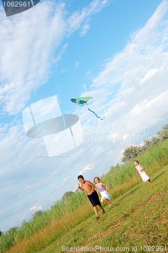 Image of children running with a kite