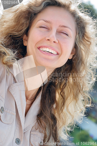 Image of happy laughing long blond hair young woman