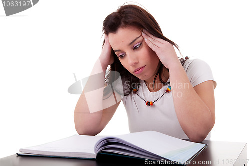 Image of woman studying with headache 
