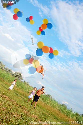 Image of children running with balloons