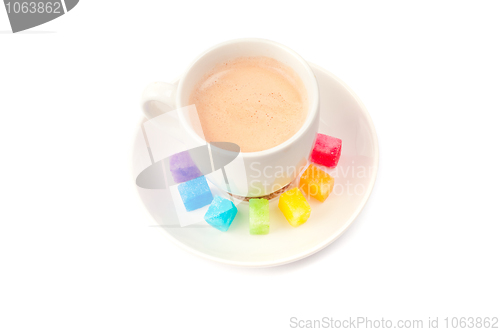 Image of Multicolored slabs of shugar and cup of coffee