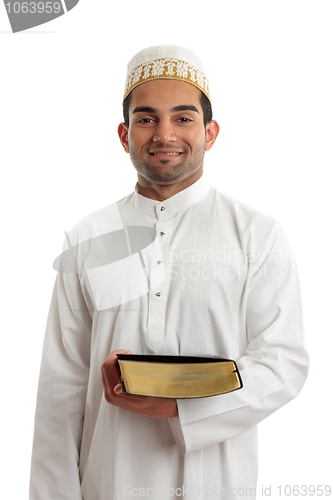 Image of Man holding a book and smiling