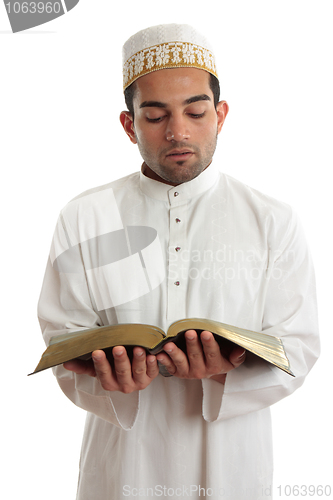 Image of Man reading a religious or other book