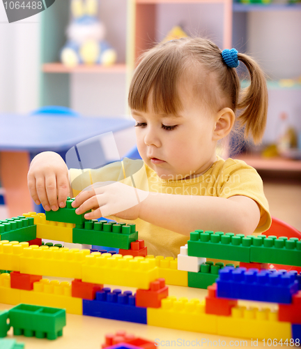 Image of Little girl play with building bricks in preschool