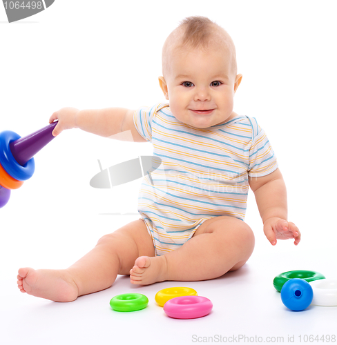 Image of Little boy play with toys