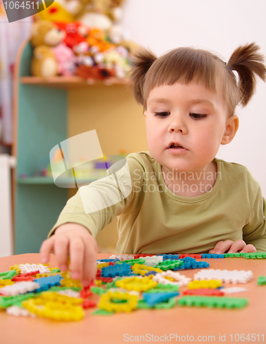Image of Little girl play with building bricks in preschool