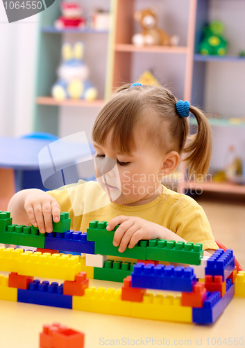 Image of Little girl play with building bricks in preschool