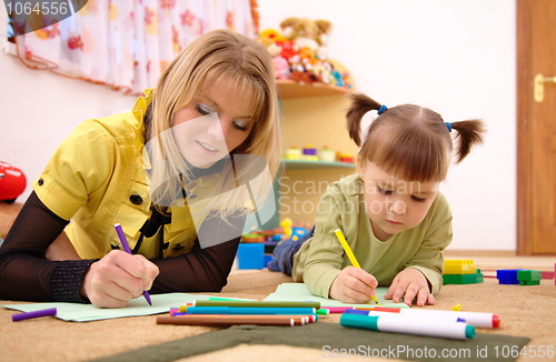 Image of Teacher with child in preschool