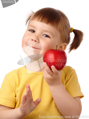 Image of Cute child is going to bite an apple