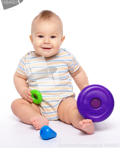 Image of Little boy play with toys