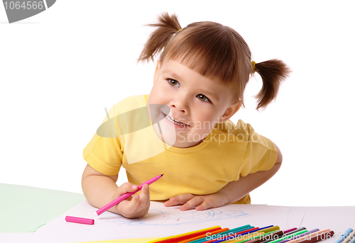 Image of Cute child draws with felt-tip pens