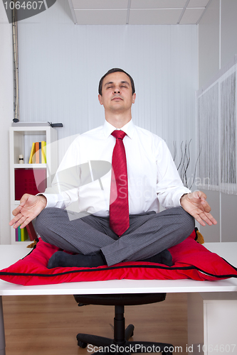 Image of Businessman relaxing at the office