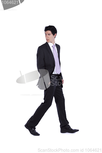 Image of Businessman walking and looking back