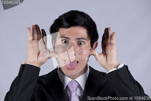 Image of Young businessman with a funny face