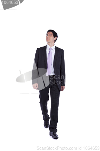 Image of Businessman walking and looking up