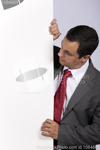 Image of Businessman holding a blank billboard