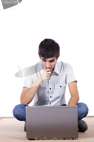 Image of Happy young man surfing the internet