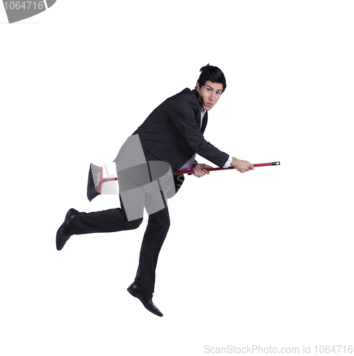 Image of Businessman flying a broom