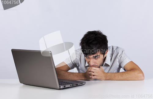 Image of Young working with his laptop