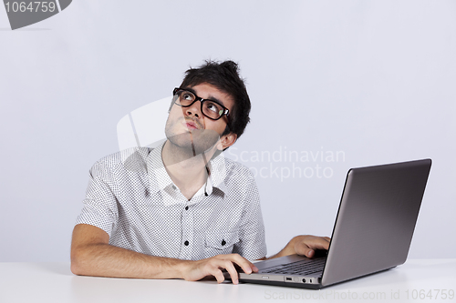 Image of Young man working with his laptop