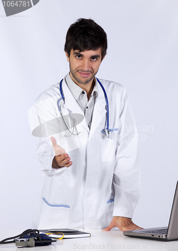 Image of frendly young doctor at his office