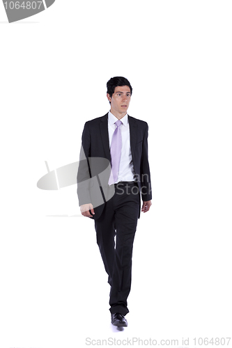 Image of Businessman walking and looking away