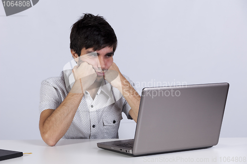 Image of Young working with his laptop