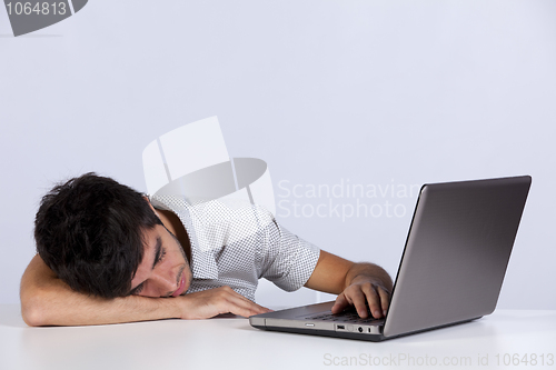 Image of Exhausted man sleeping at his office