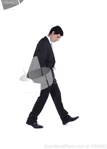 Image of Businessman walking and looking down