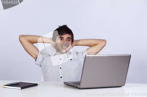 Image of Modern businessman relaxing at his office