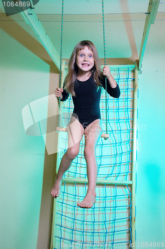 Image of child at her home sports gym swinging