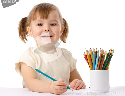 Image of Cute child draws with color pencils