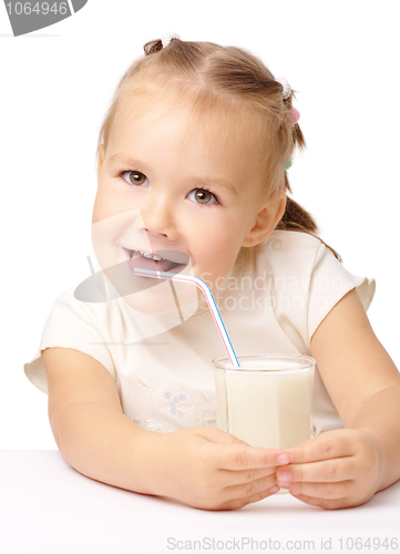 Image of Little girl drinks milk using drinking straw