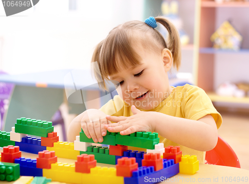 Image of Little girl play with building bricks in preschool