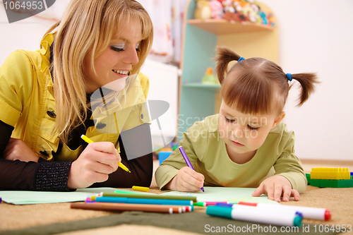 Image of Teacher with child in preschool
