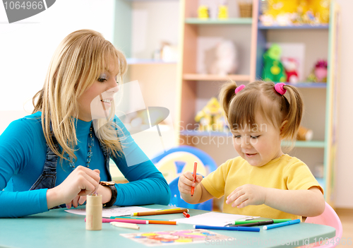 Image of Teacher with child in preschool