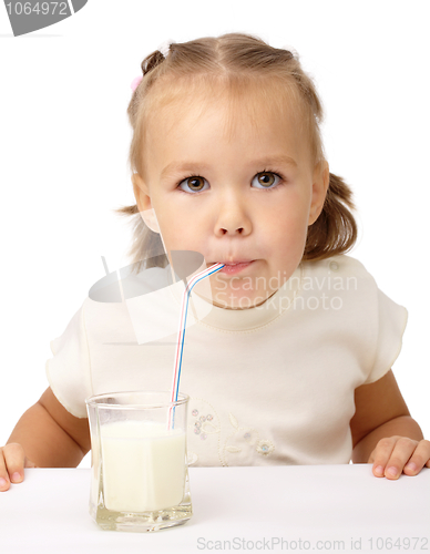 Image of Little girl drinks milk using drinking straw