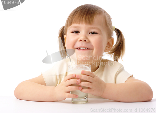 Image of Little girl drinks milk