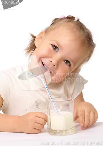 Image of Little girl drinks milk using drinking straw