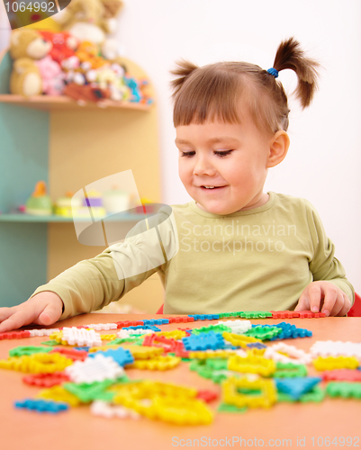 Image of Little girl play with building bricks in preschool