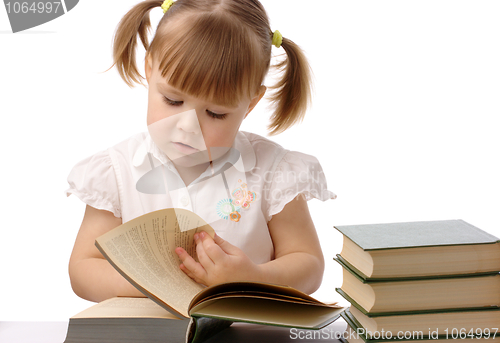 Image of Cute little girl is reading book, back to school