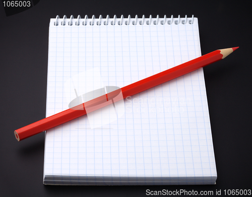 Image of Blank notepad and a pencil on black