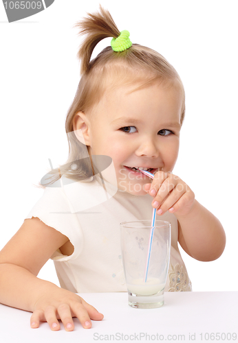 Image of Little girl drinks milk using drinking straw
