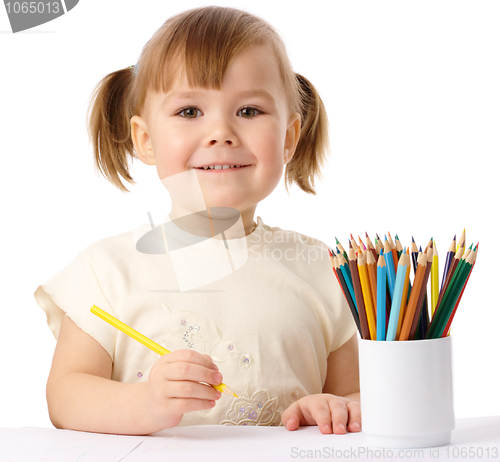 Image of Cute child draws with color pencils