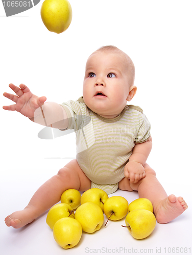 Image of Little boy play with apples