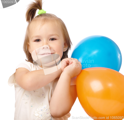 Image of Cute little girl with two colored balloons