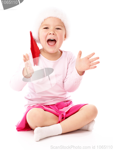 Image of Little girl wearing red Christmas cap