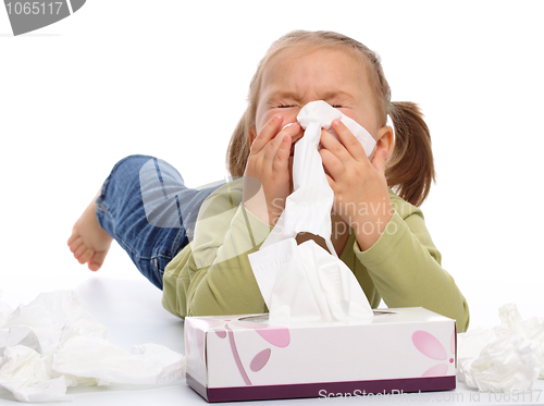 Image of Little girl blows her nose